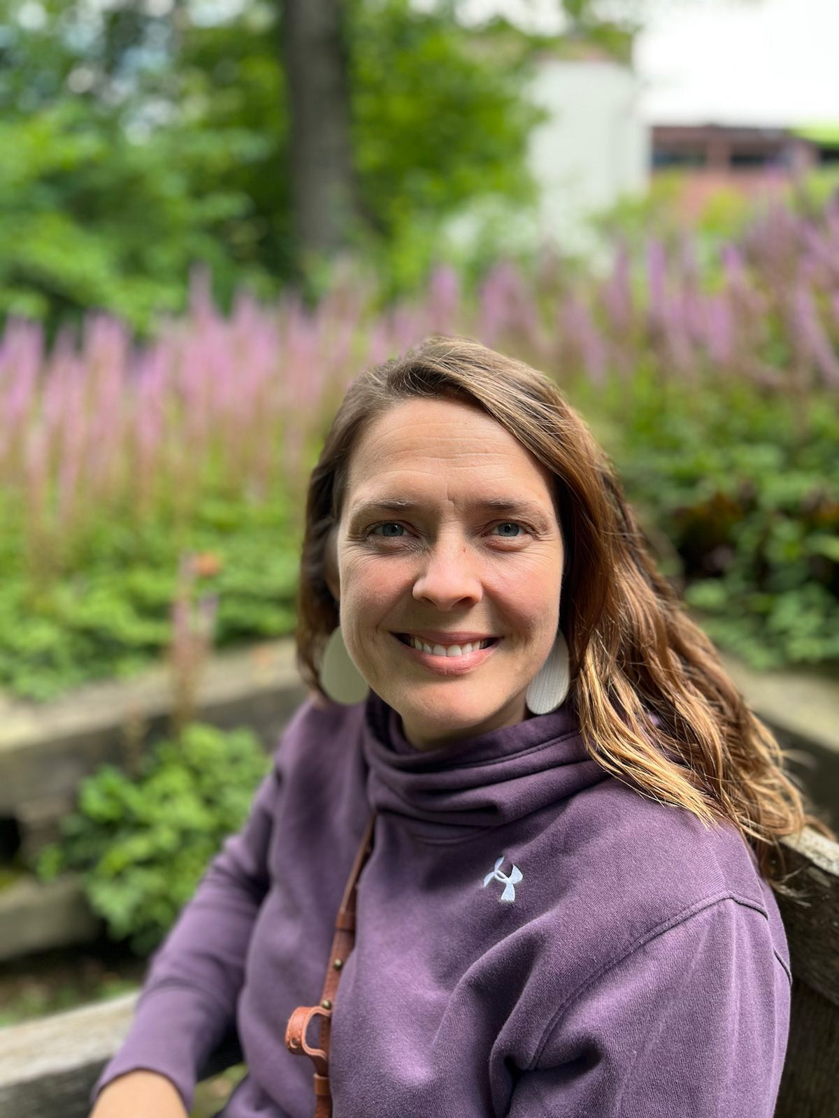 Angela smiling in a garden setting